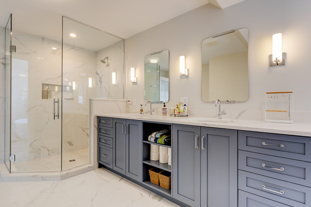 blue cabinets in a white residential bathroom